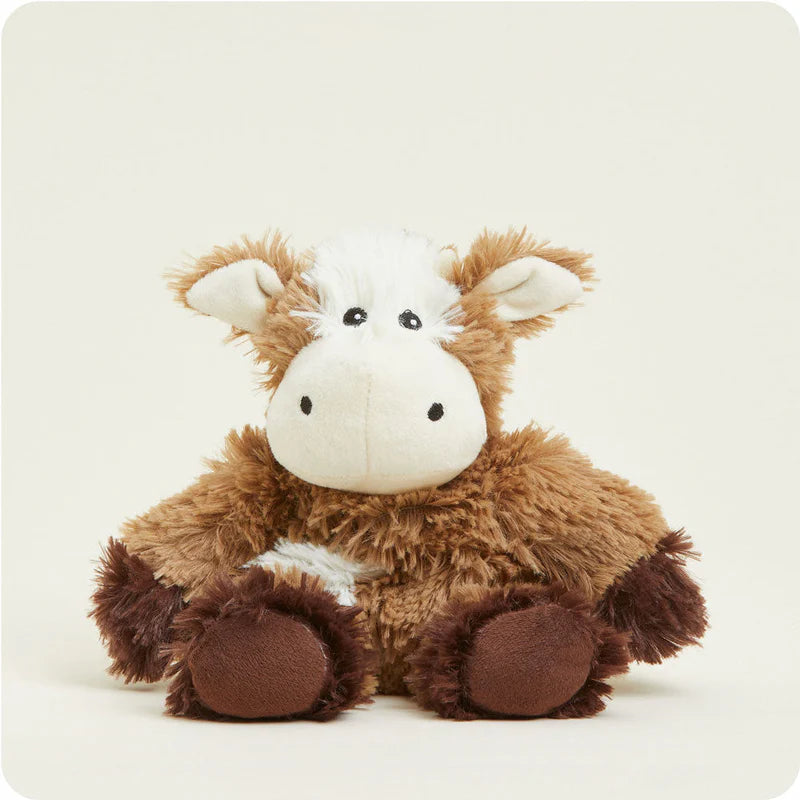 Plush cow toy on a white background