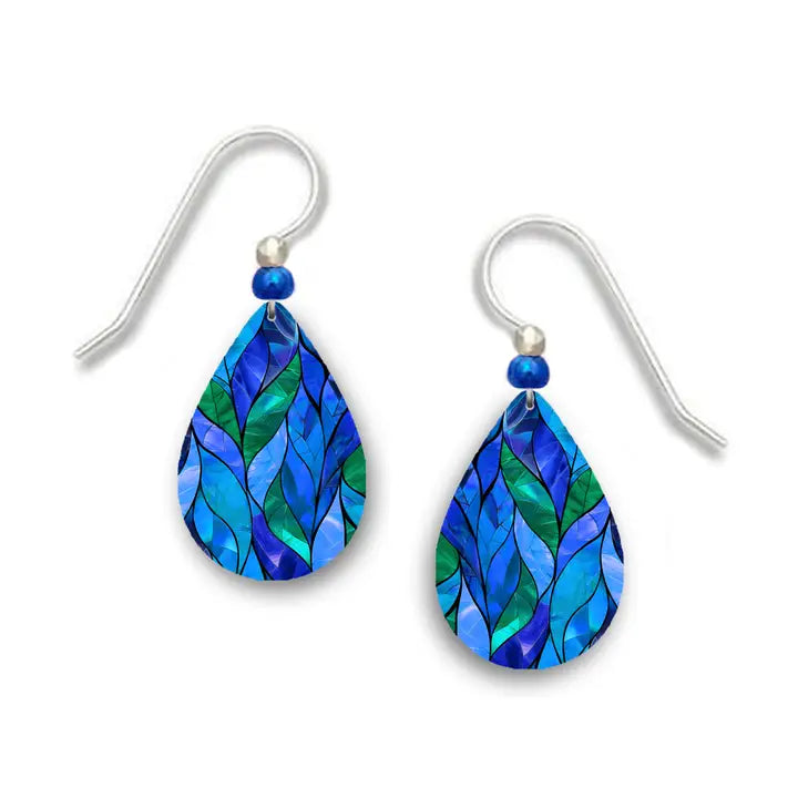 Teal and blue patterned earrings with silver hooks on a white background