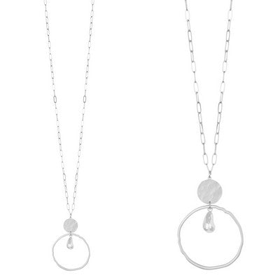 Two silver necklaces with circular pendants on a white background