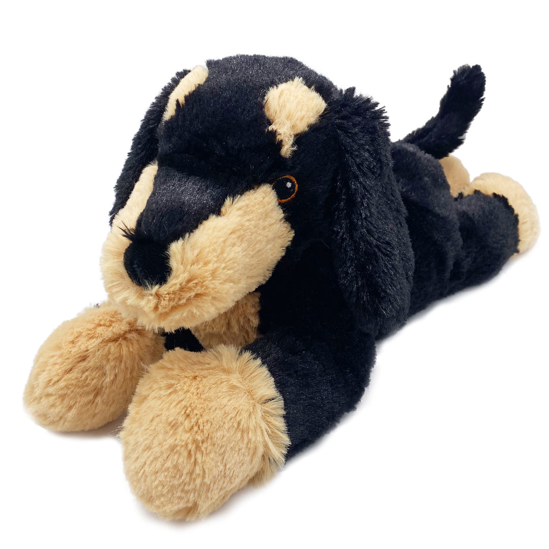 Plush toy dog with black and beige fur on a white background