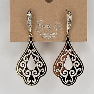 Pair of ornate teardrop earrings on a Betty Olu branded card.
