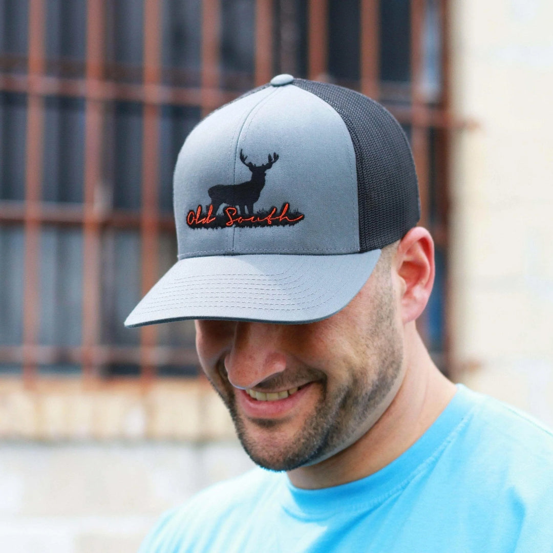 man wearing a gray trucker hat with black deer graphic
