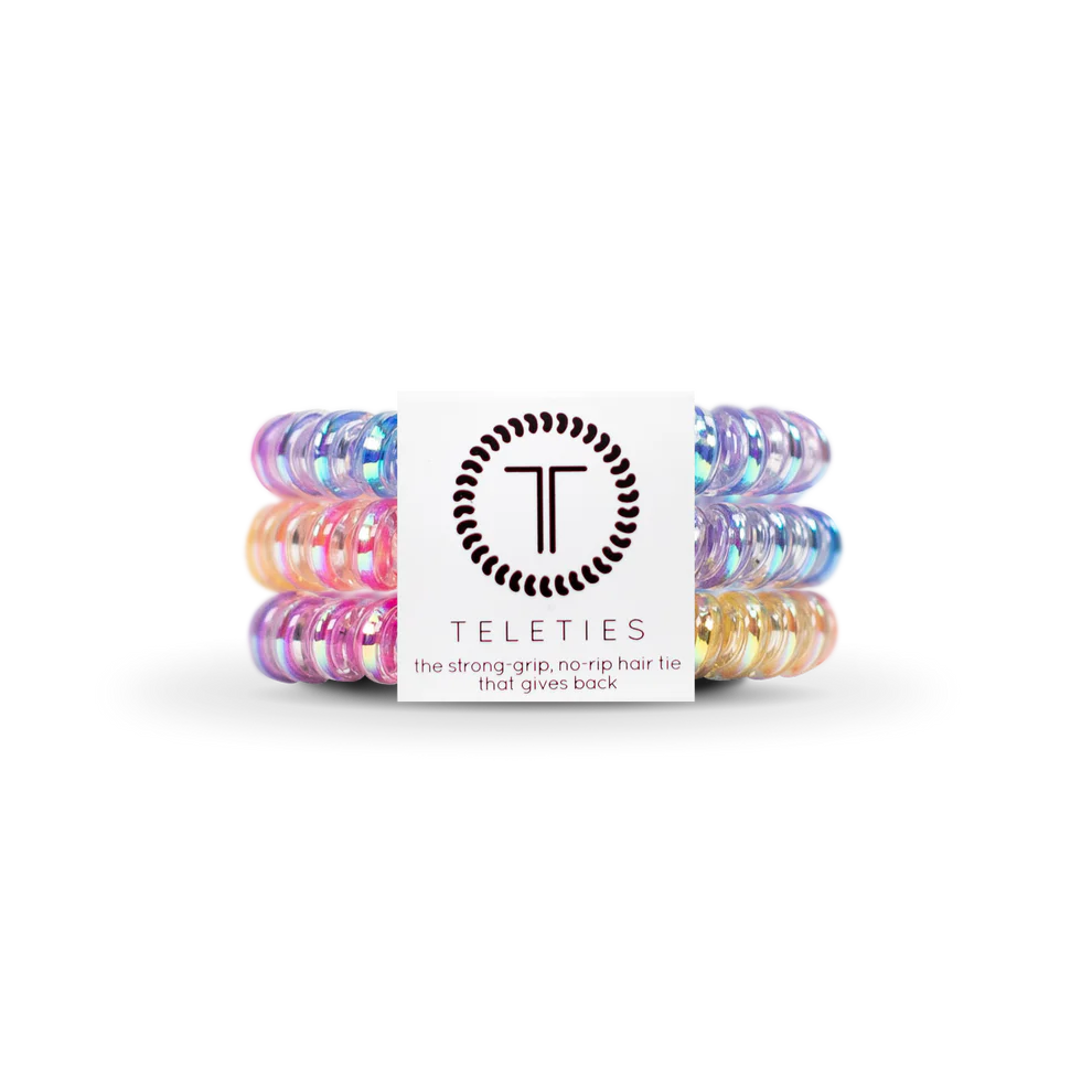 Set of colorful hair ties with a Teleties branded box on a white background