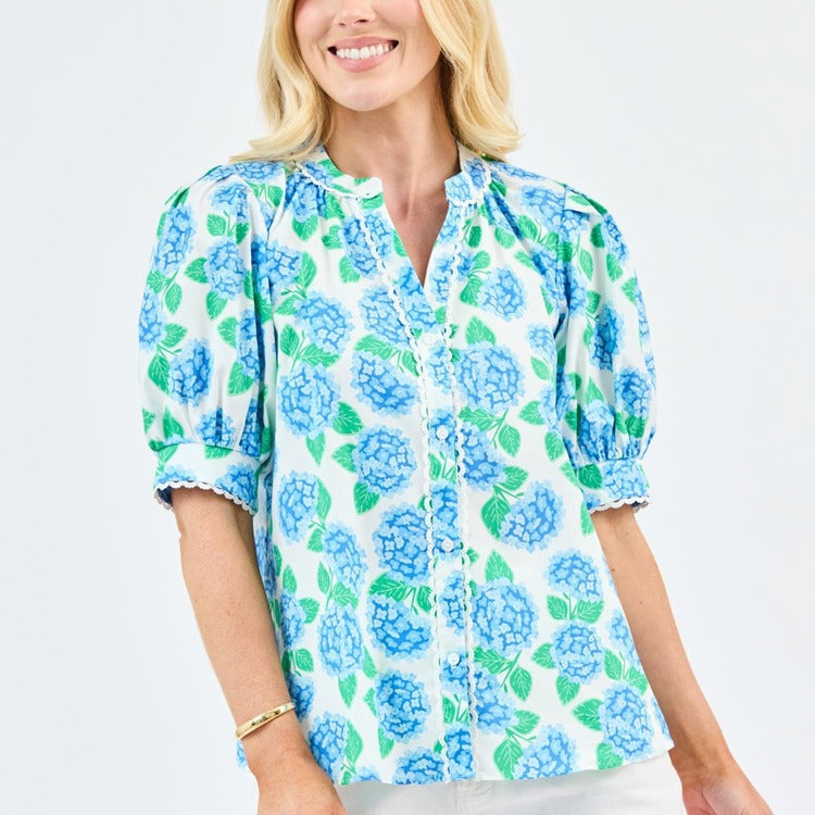 Woman wearing a blue floral blouse on a white background