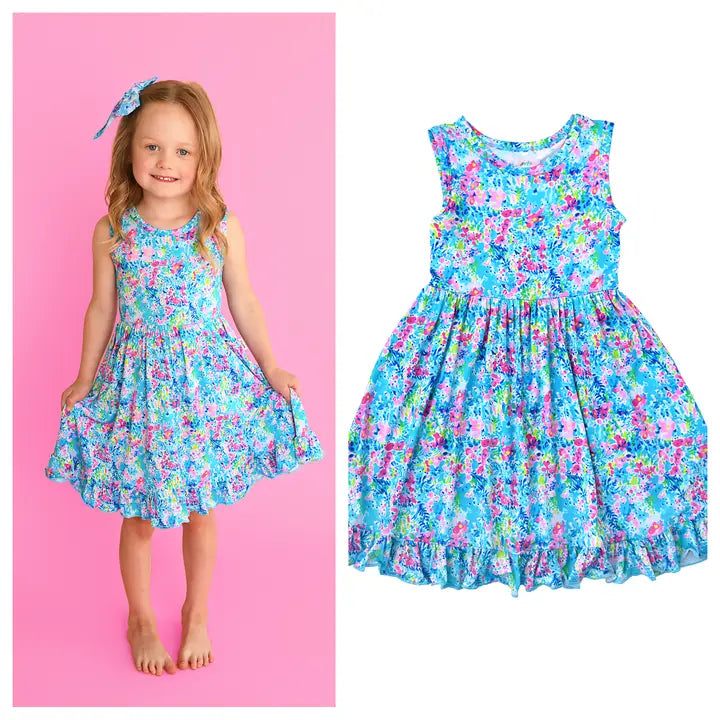 Child wearing a floral dress on a pink background