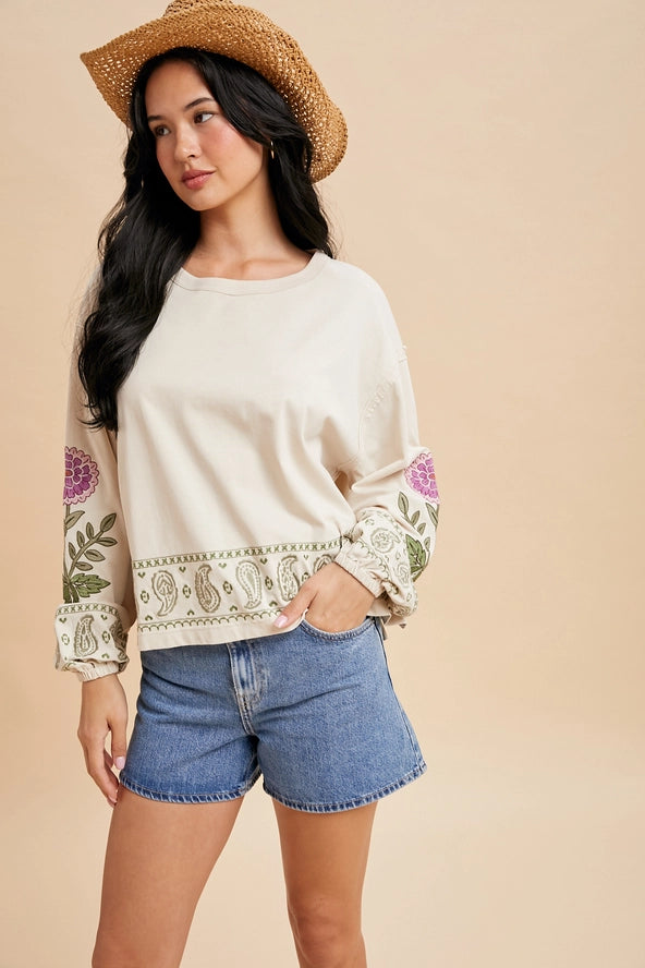 Cream Colored Long Sleeve Top with Embroidery on the sleeves and hem