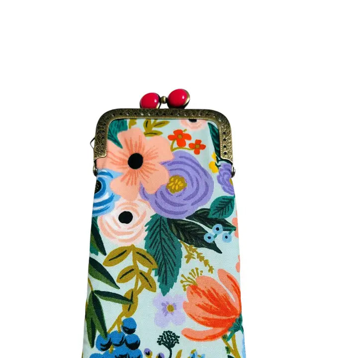 Floral phone case with a decorative clasp on a white background