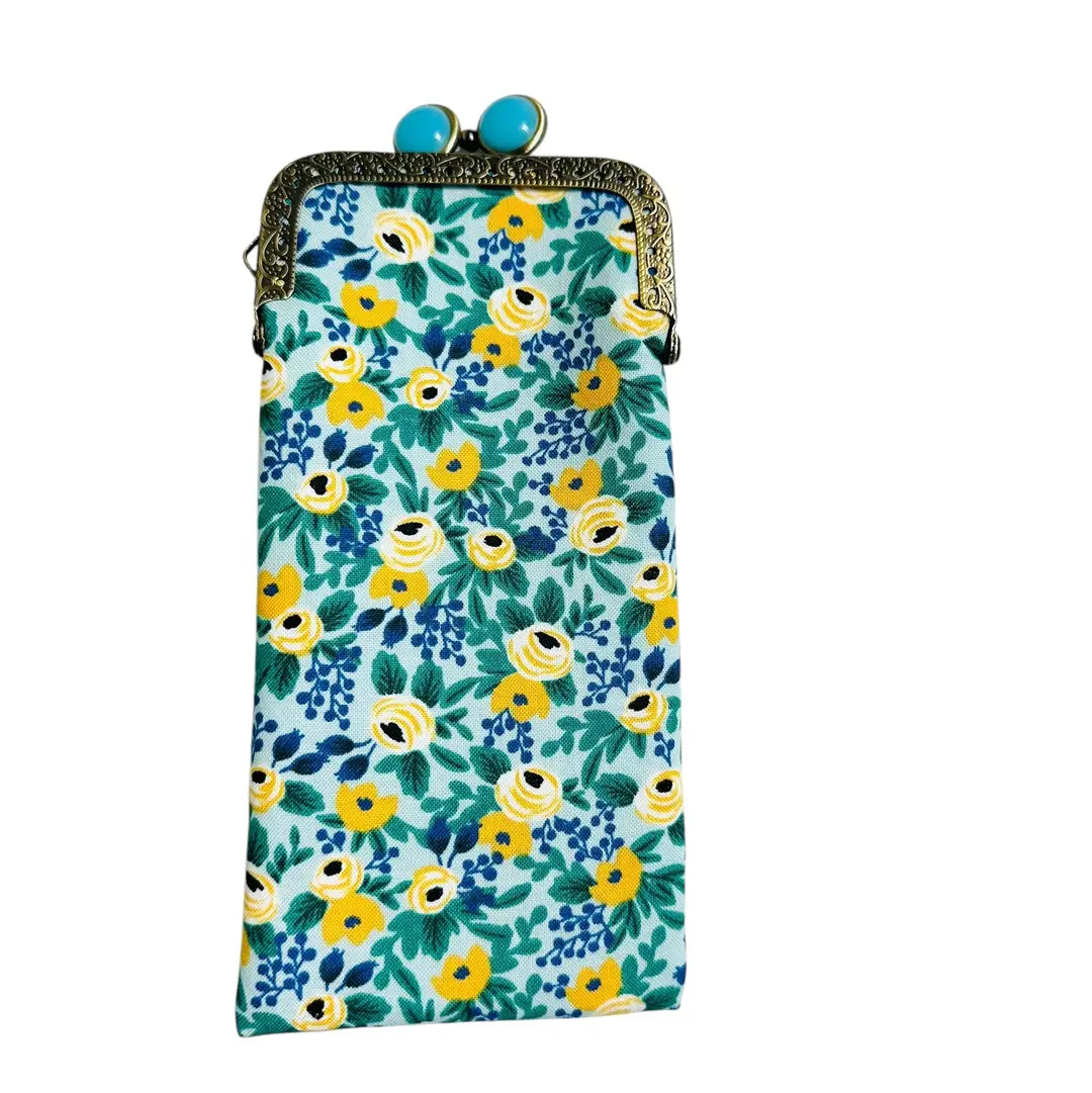 Floral patterned pouch with a decorative clasp on a white background