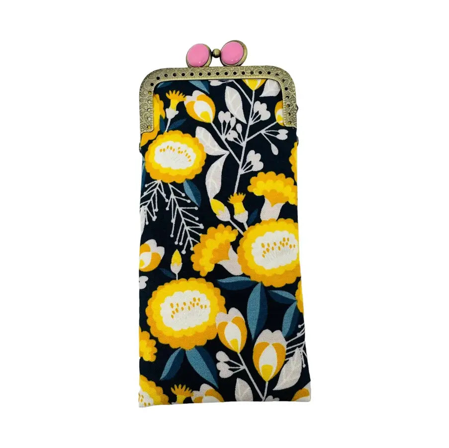 Floral patterned pouch with a gold frame and pink clasp on a white background