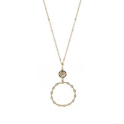 Gold necklace with a circular pendant on a white background