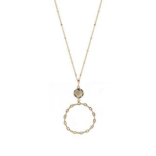 Gold necklace with a circular pendant on a white background