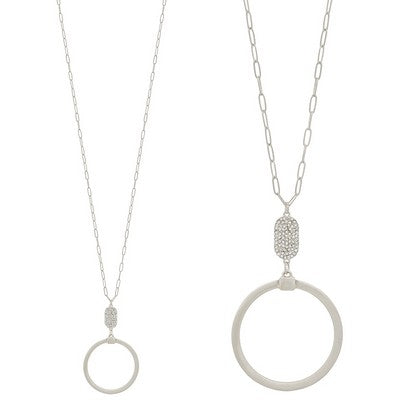 Two silver necklaces with circular pendants on a white background