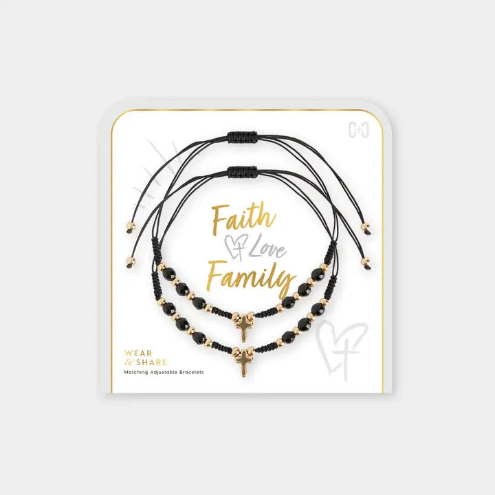 Set of black and gold bracelets on a white card with 'Faith Love Family' text