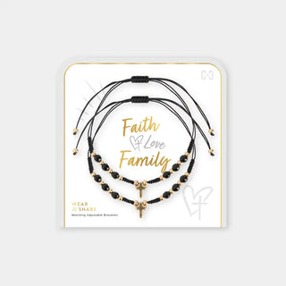 Set of black and gold bracelets on a white card with 'Faith Love Family' text