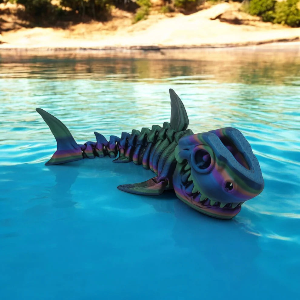 Colorful shark skeleton toy floating in a pool with a natural landscape in the background