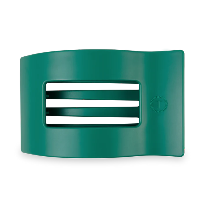 Green plastic clip with a white rectangular slot on a white background
