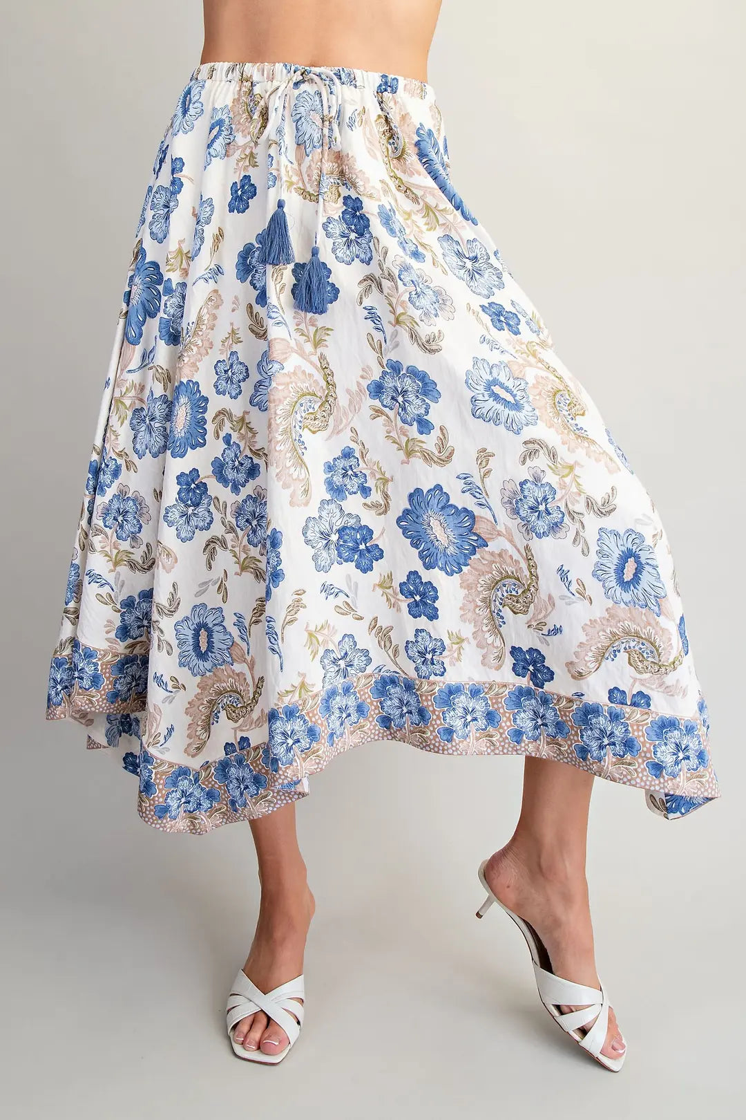 Floral patterned skirt worn by a person on a plain background