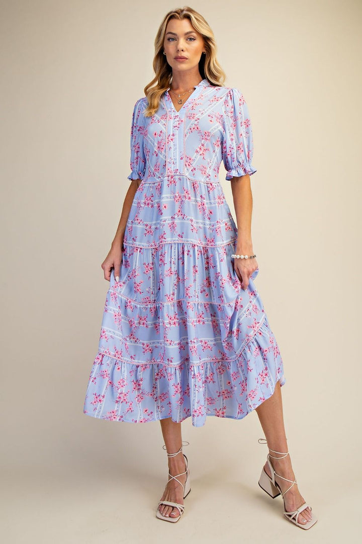 Woman wearing a blue floral dress on a beige background