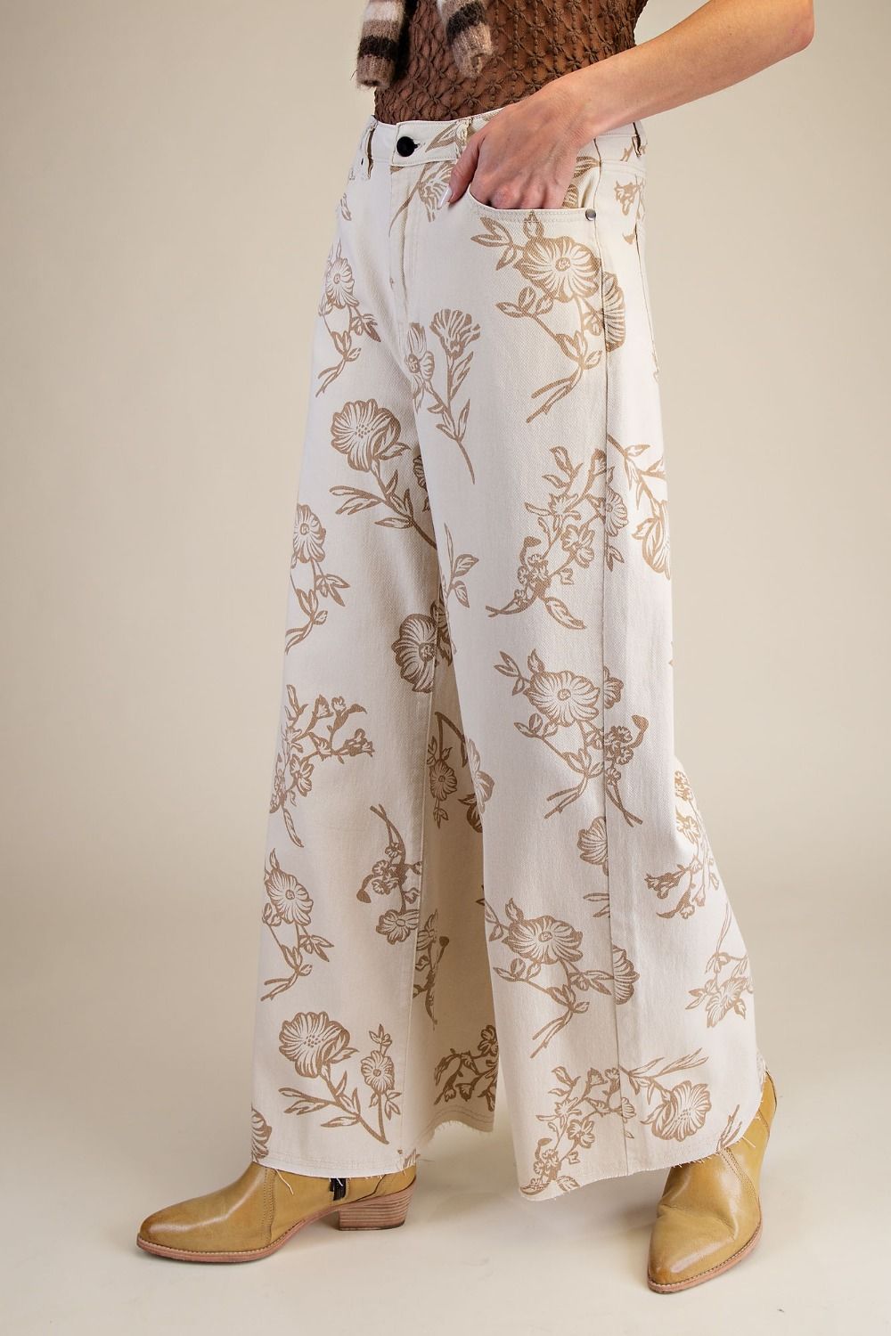 Floral-patterned pants worn by a person on a plain background