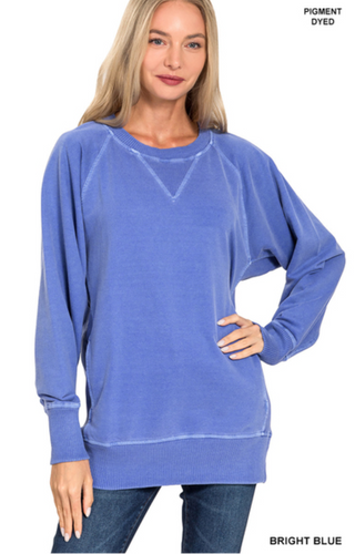 Woman wearing a bright blue sweater on a white background