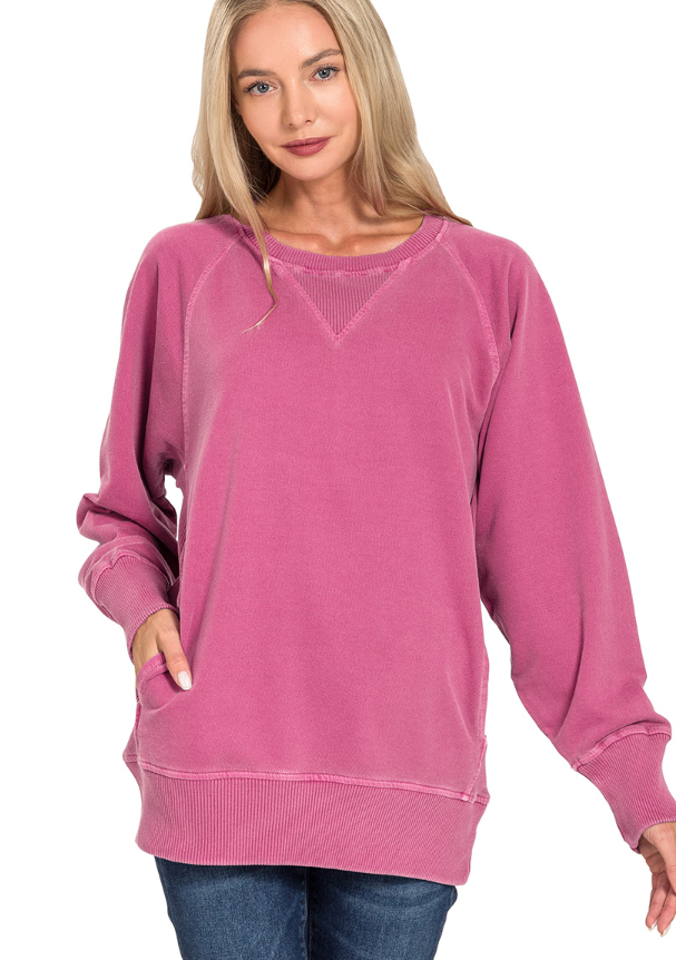 Woman wearing a pink sweatshirt on a white background