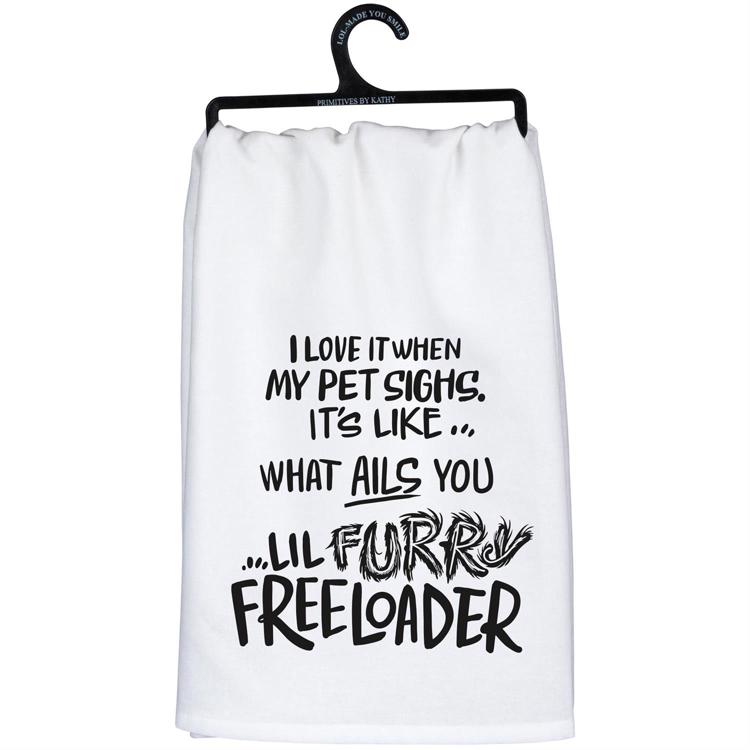 White towel with humorous text on a hanger against a white background