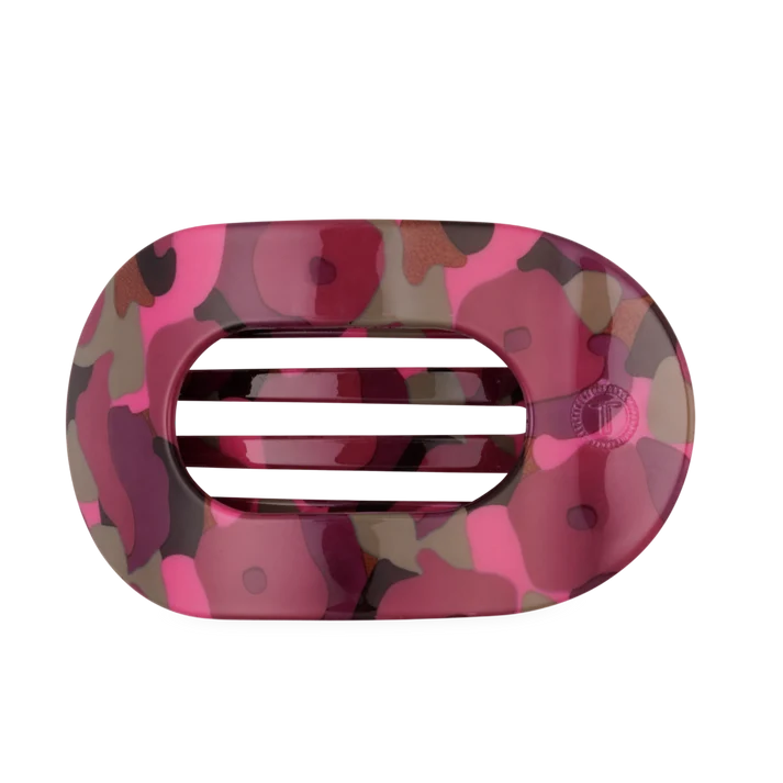 oval shaped flat hair clip with pink, brown, and green tones