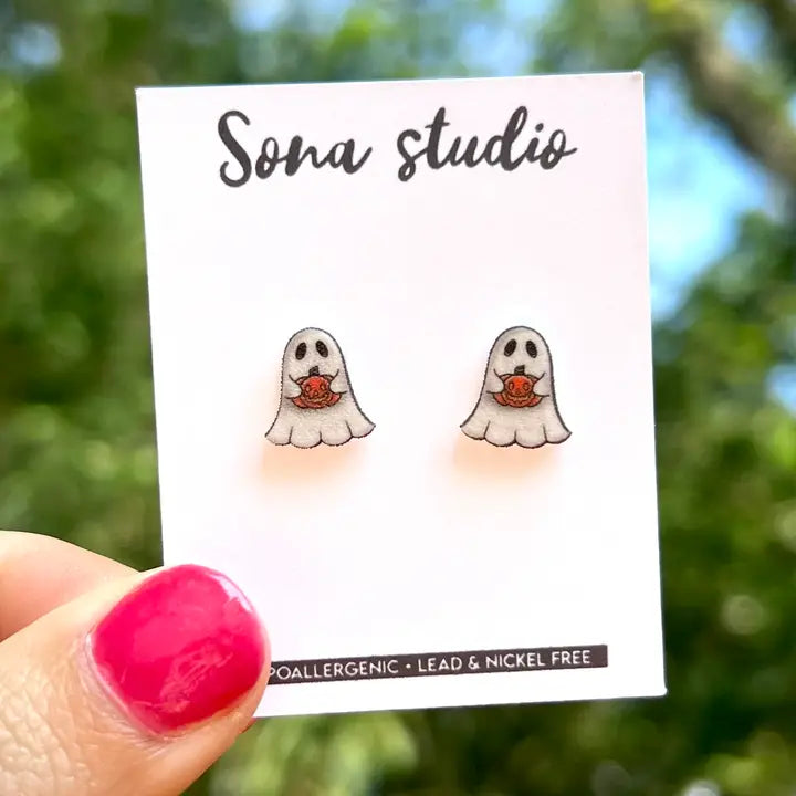 Ghost-shaped earrings on a Sona Studio card with a blurred natural background