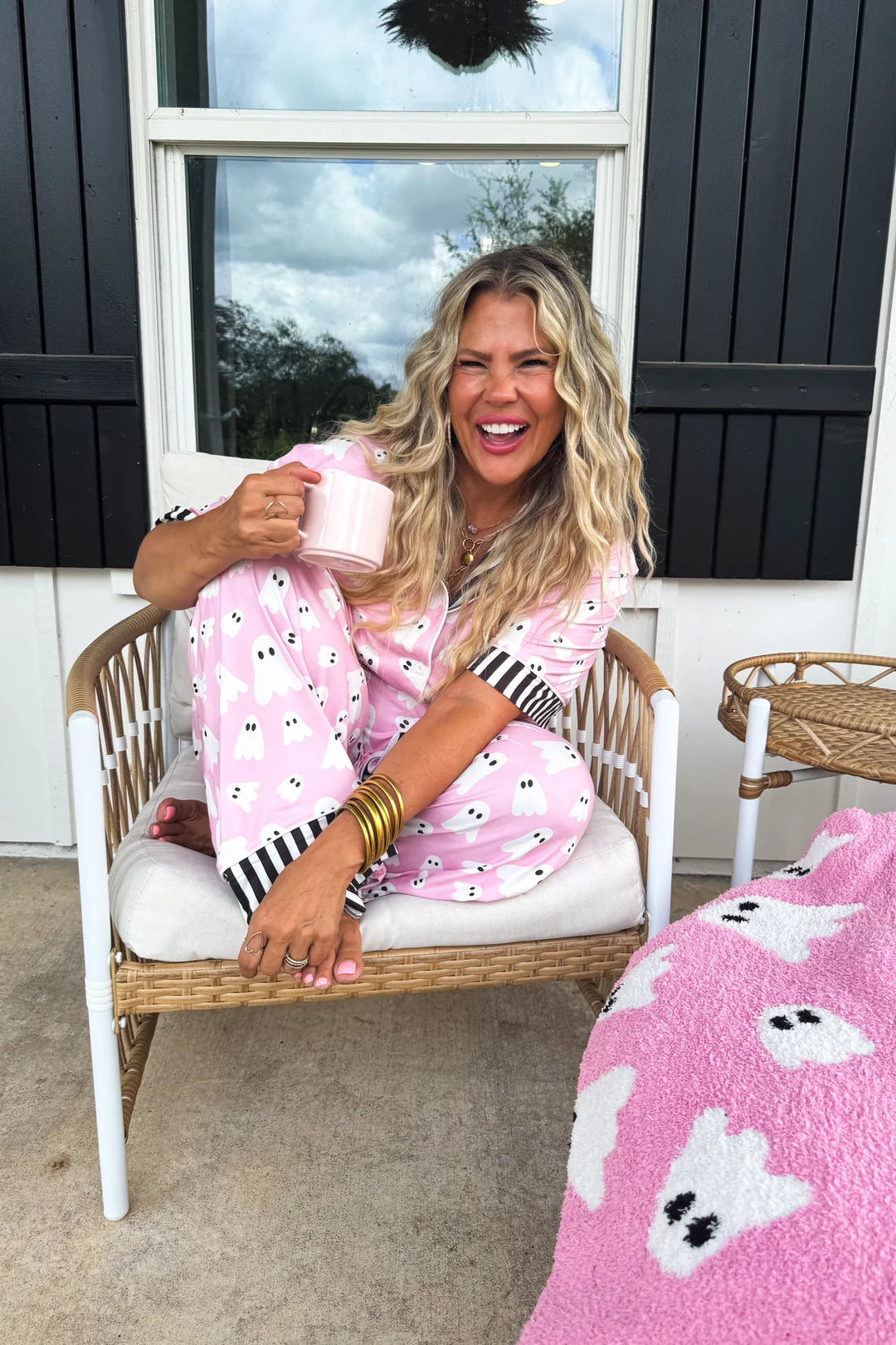 woman sitting in chair wearing pink ghost pajamas