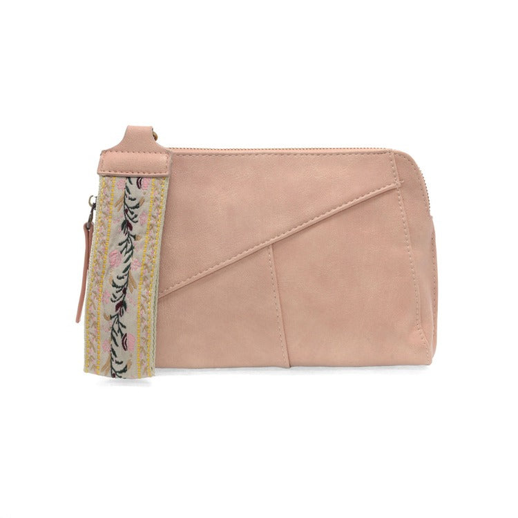 Pink clutch bag with a floral strap on a white background