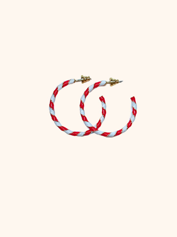 Pair of red and white hoop earrings on a white background