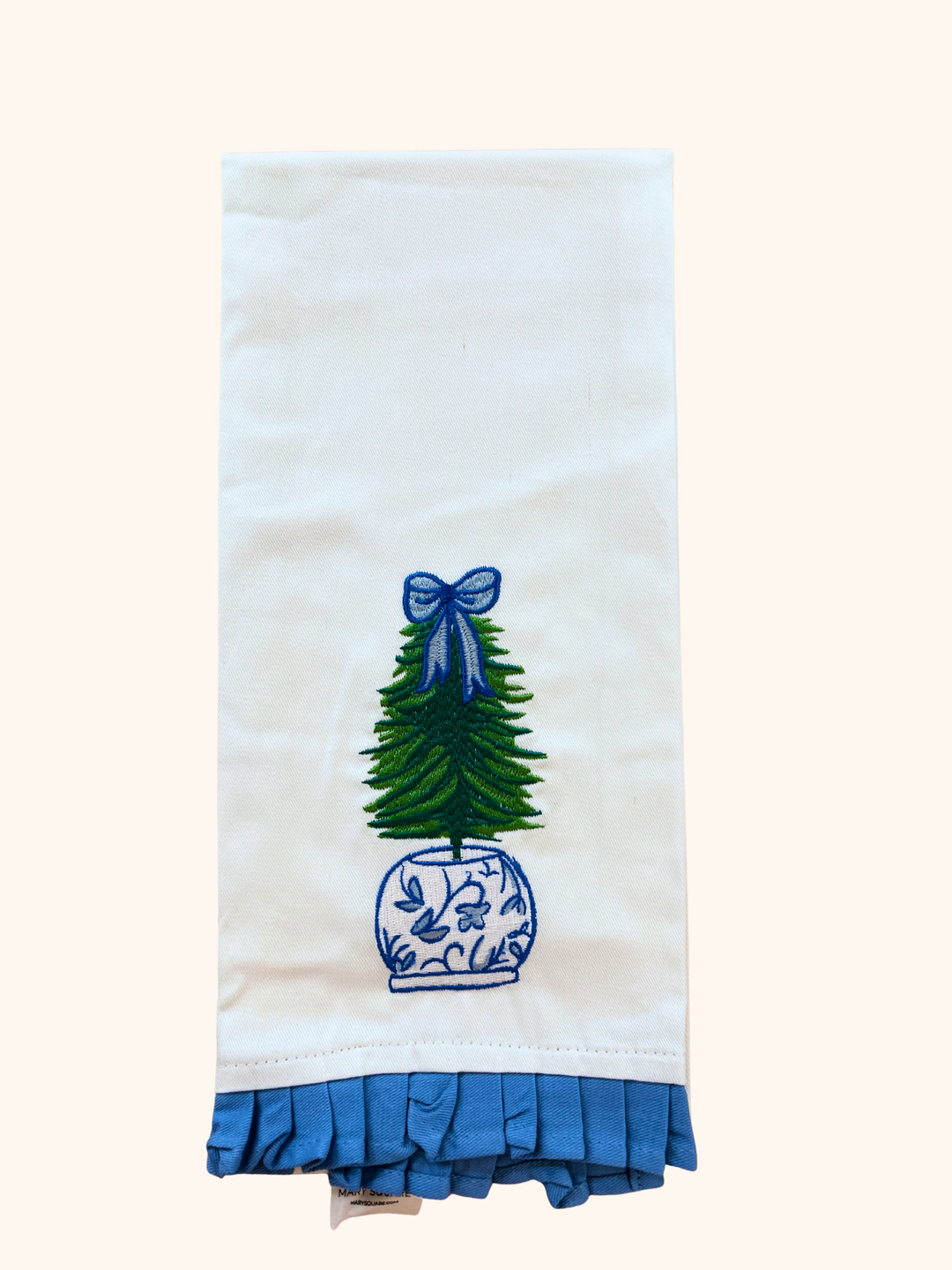 Decorative towel with a tree and bow design on a white background