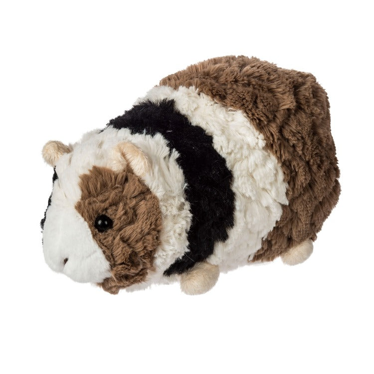 Plush toy resembling a guinea pig with brown, white, and black colors on a white background