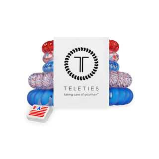 Set of colorful hair ties with a Teleties branded box on a white background