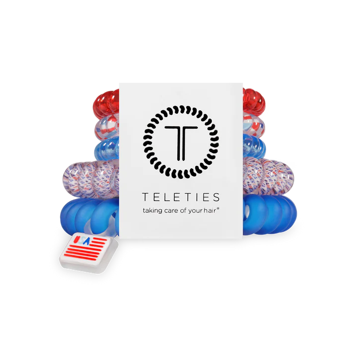 Set of colorful hair ties with a Teleties branded box on a white background
