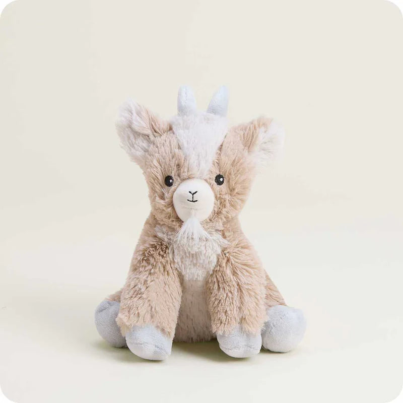 Plush toy goat with a white face on a light beige background