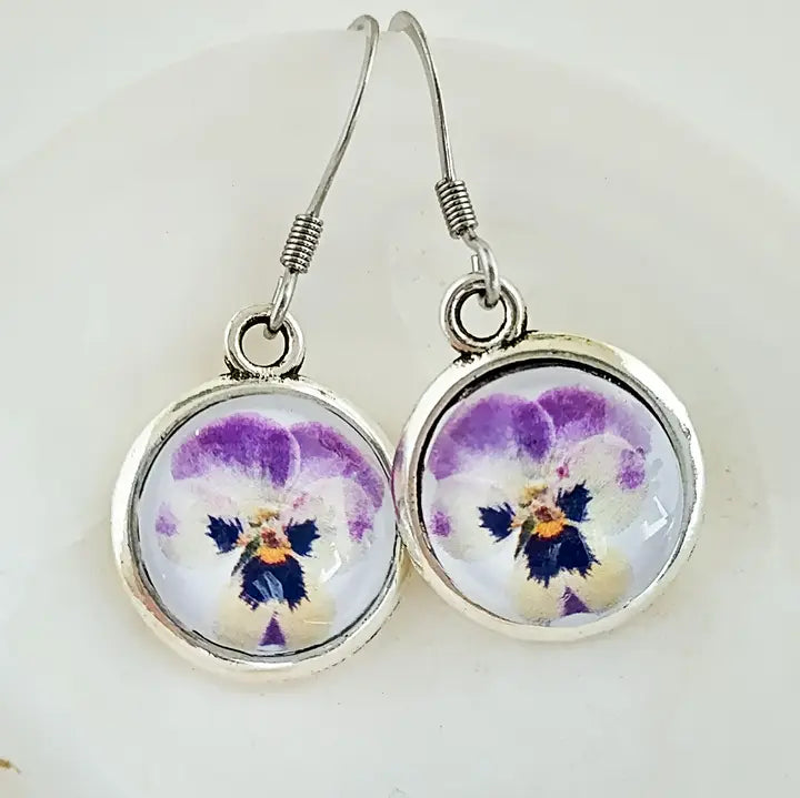 Pair of earrings with floral design on a white background
