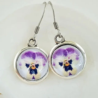 Pair of earrings with floral design on a white background