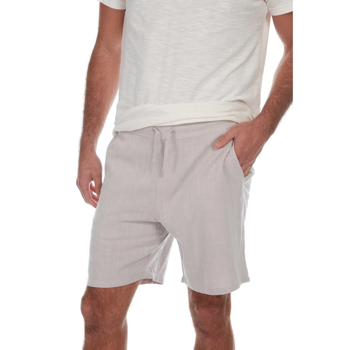 Person wearing light gray shorts and a white t-shirt on a white background