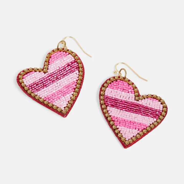 Heart-shaped earrings with pink and gold design on a white background