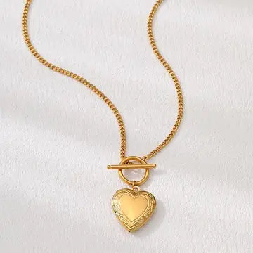 Gold heart-shaped pendant on a chain against a white background