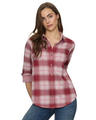 A woman modeling a red and pink plaid button-down shirt with rolled-up sleeves, paired with blue jeans, against a plain white background.