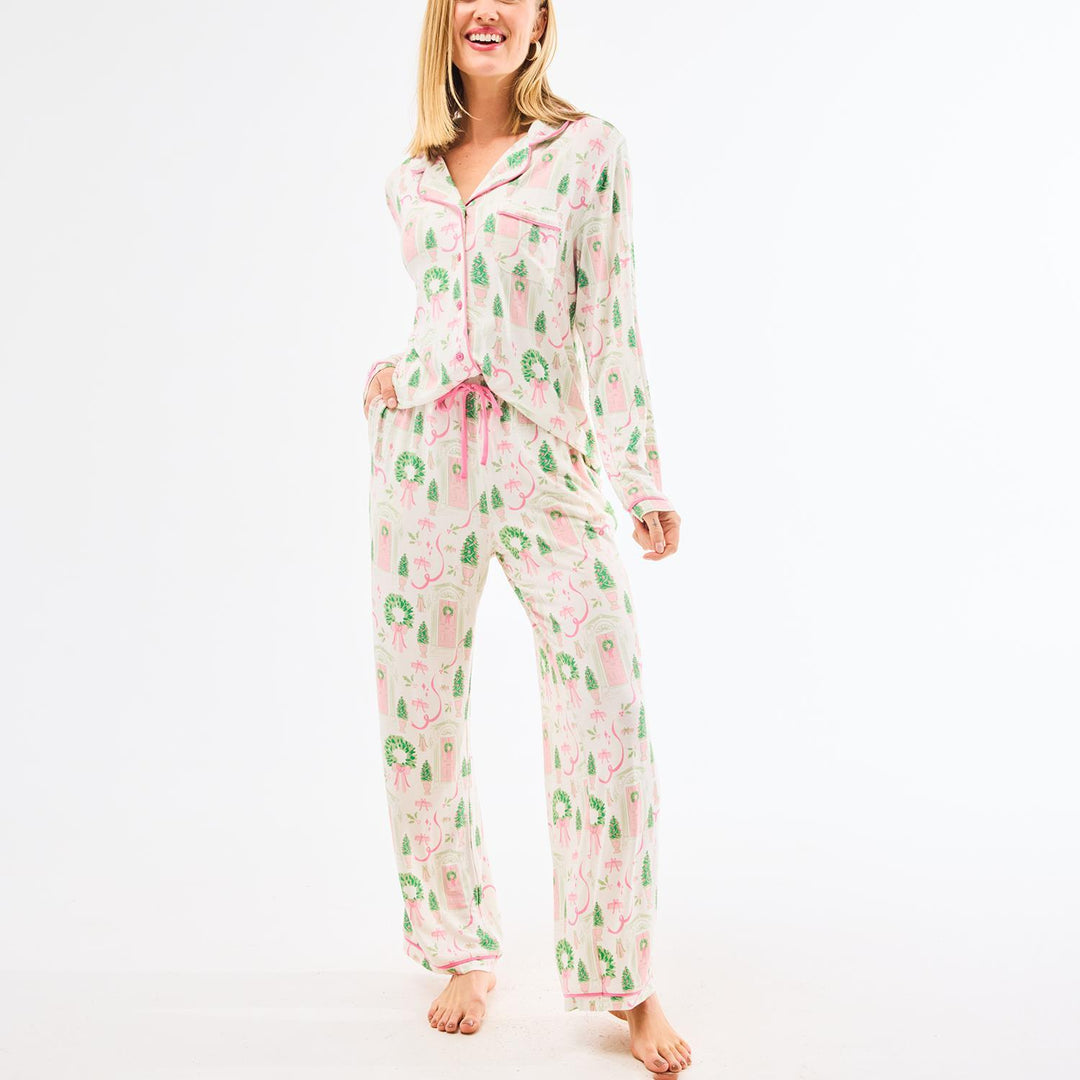 Woman wearing a pink and green pajama set on a white background