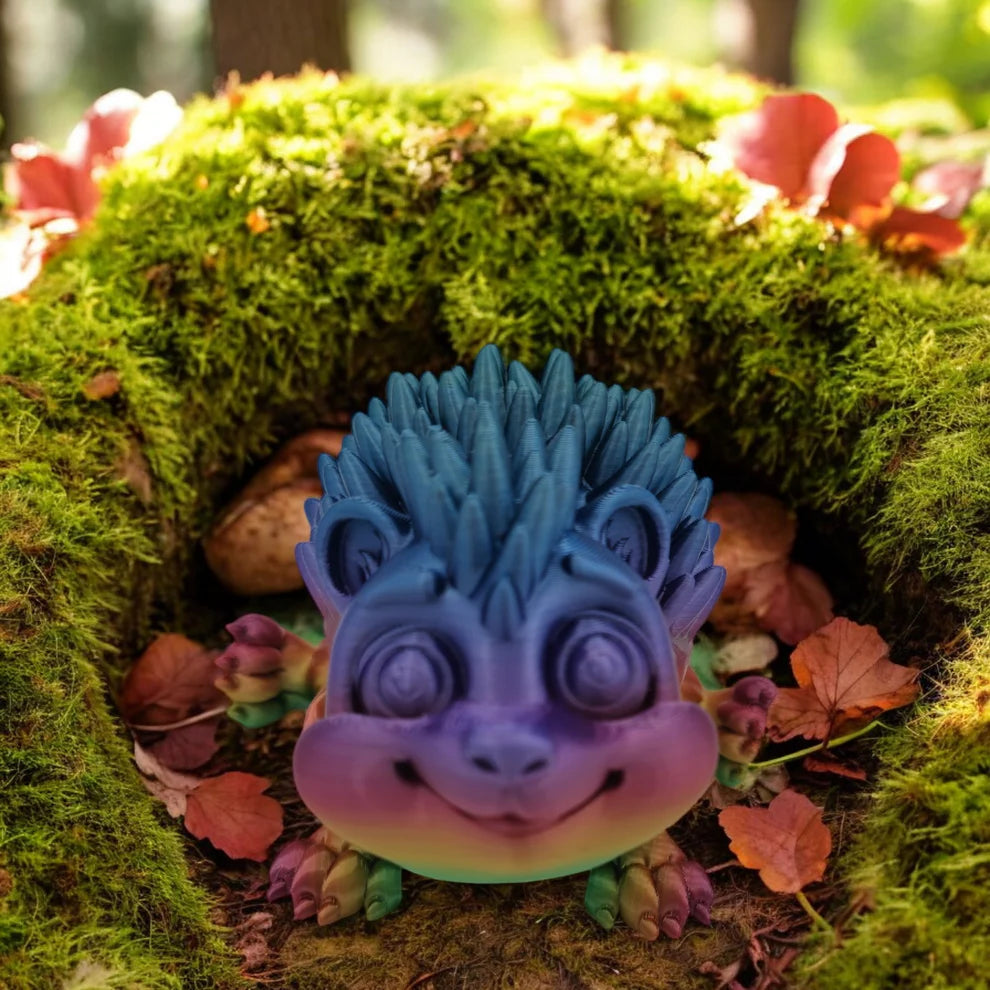 Colorful dragon-like figurine on a mossy surface with autumn leaves