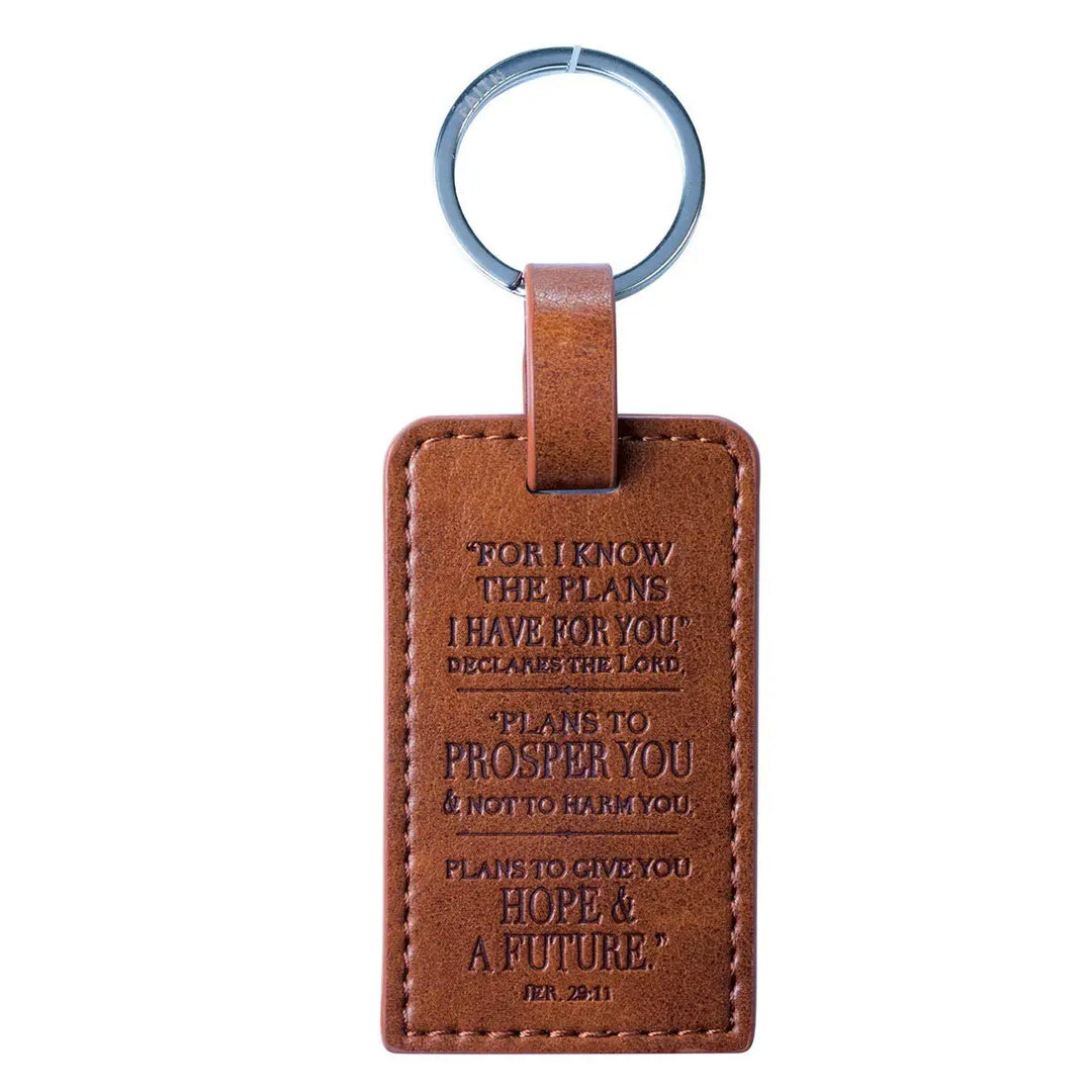 Brown leather keychain with engraved text on a white background