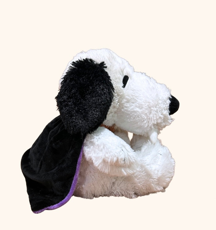 Plush dog toy with a black cape on a white background