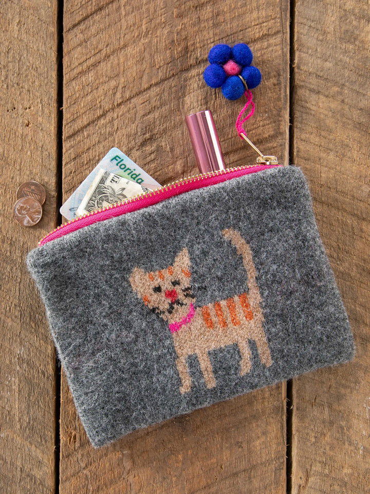 Gray pouch with embroidered cat design on a wooden surface
