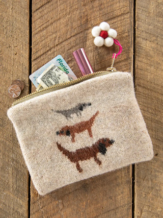 Small pouch with dog illustrations on a wooden surface