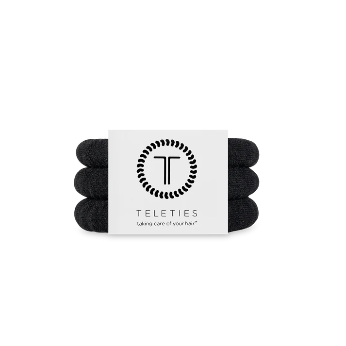 Set of black hair ties with a Teleties label on a white background