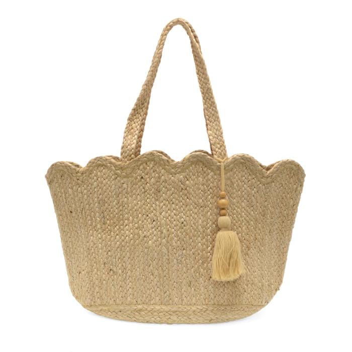 Woven handbag with a scalloped edge and tassel on a white background